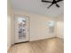Bright bedroom featuring wood-look floors, a ceiling fan, and a glass panel door to the backyard patio at 3861 S Acacia Ct, Chandler, AZ 85248