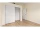Bedroom with wood floors, a sliding closet, and a door to the rest of the home at 3861 S Acacia Ct, Chandler, AZ 85248