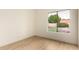Light-filled bedroom with wood-look floors, a window overlooking a pool and backyard at 3861 S Acacia Ct, Chandler, AZ 85248