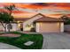 Inviting single-Gathering home featuring a two-car garage, lush green lawn, and southwestern landscaping at 3861 S Acacia Ct, Chandler, AZ 85248