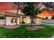 Inviting single-Gathering home featuring a two-car garage, lush green lawn, and desert landscaping at 3861 S Acacia Ct, Chandler, AZ 85248