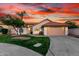 Inviting single-Gathering home featuring a two-car garage, lush green lawn, and southwestern landscaping at 3861 S Acacia Ct, Chandler, AZ 85248