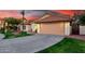 Charming single-Gathering home featuring a two-car garage and lush green lawn with desert landscaping at 3861 S Acacia Ct, Chandler, AZ 85248