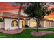 Inviting single-Gathering home featuring a two-car garage, lush green lawn, and desert landscaping at 3861 S Acacia Ct, Chandler, AZ 85248