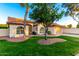 Charming single-story home featuring a well-manicured lawn, desert landscaping, and a two-car garage at 3861 S Acacia Ct, Chandler, AZ 85248