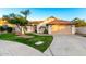 Charming single-story home featuring a well-manicured lawn, desert landscaping, and a two-car garage at 3861 S Acacia Ct, Chandler, AZ 85248
