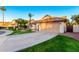 Charming single-story home featuring a well-manicured lawn, desert landscaping, and a two-car garage at 3861 S Acacia Ct, Chandler, AZ 85248