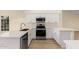 Modern kitchen with sleek white cabinetry, stainless steel appliances, and white countertops at 3861 S Acacia Ct, Chandler, AZ 85248