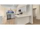 Bright kitchen featuring white cabinets, modern appliances, quartz counters, and wood-look flooring at 3861 S Acacia Ct, Chandler, AZ 85248