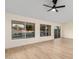 Bright, empty living room with modern wood-look flooring and large windows overlooking a pool at 3861 S Acacia Ct, Chandler, AZ 85248