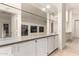 Living Room featuring a mirror wall and white cabinets with light countertops at 3861 S Acacia Ct, Chandler, AZ 85248