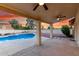 Covered patio with ceiling fans overlooking a pristine pool, enhanced by a beautiful sunset at 3861 S Acacia Ct, Chandler, AZ 85248