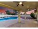 Covered patio with ceiling fans overlooking a pristine pool, enhanced by a beautiful sunset at 3861 S Acacia Ct, Chandler, AZ 85248