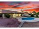 Backyard pool with a tiled roof patio under a colorful evening sky at 3861 S Acacia Ct, Chandler, AZ 85248