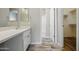 Bathroom featuring laminate flooring, a vanity, and a view into the shower at 39894 N Fazio Ln, San Tan Valley, AZ 85140