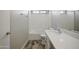 Bathroom with a quartz countertop vanity, updated fixtures and wood-look tile floors at 39894 N Fazio Ln, San Tan Valley, AZ 85140
