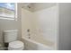 Bright bathroom featuring a tub with white tile surround and a window for natural light at 39894 N Fazio Ln, San Tan Valley, AZ 85140
