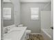 Bright bathroom with a quartz countertop vanity and wood-look tile floors at 39894 N Fazio Ln, San Tan Valley, AZ 85140