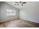 Bright bedroom with ceiling fan, laminate floors, and a sunlit window at 39894 N Fazio Ln, San Tan Valley, AZ 85140