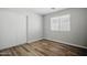 A light-filled bedroom features a closet with sliding doors and wood-look flooring at 39894 N Fazio Ln, San Tan Valley, AZ 85140