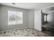 A sunlit bedroom features wood-look floors and a large window with blinds at 39894 N Fazio Ln, San Tan Valley, AZ 85140