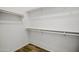 Spacious walk-in closet with built-in shelving and wooden floor, providing ample storage space at 39894 N Fazio Ln, San Tan Valley, AZ 85140