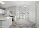 Bright kitchen featuring white cabinets, an island, and views of the backyard at 39894 N Fazio Ln, San Tan Valley, AZ 85140