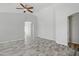 Bright living room with high ceilings, a ceiling fan and wood-look tile floors at 39894 N Fazio Ln, San Tan Valley, AZ 85140