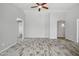 Living room with archways, high ceilings, ceiling fan and wood-look tile floors at 39894 N Fazio Ln, San Tan Valley, AZ 85140
