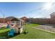 Bright backyard with artificial grass and play structures offers a vibrant outdoor space for activities and play at 40467 W Jenna Ln, Maricopa, AZ 85138
