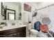 Well-lit bathroom with a stylish shower curtain and decor at 40467 W Jenna Ln, Maricopa, AZ 85138