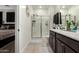 Bright bathroom featuring a double vanity, glass enclosed shower and toilet at 40467 W Jenna Ln, Maricopa, AZ 85138