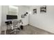 Bright office space with a standing desk and shelves for storage at 40467 W Jenna Ln, Maricopa, AZ 85138