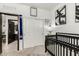 Bright Bedroom featuring a dark crib and decor at 40467 W Jenna Ln, Maricopa, AZ 85138