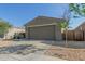 Close up front exterior view of single story home with a well maintained yard and neutral color paint at 40467 W Jenna Ln, Maricopa, AZ 85138