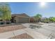 A single story home with a two car garage, desert landscaping, and neutral exterior paint at 40467 W Jenna Ln, Maricopa, AZ 85138