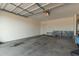 Spacious garage with concrete floor and an automatic door at 40467 W Jenna Ln, Maricopa, AZ 85138