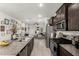 Open kitchen featuring a stainless steel refrigerator and a large island with granite countertops at 40467 W Jenna Ln, Maricopa, AZ 85138