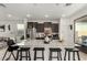 Modern kitchen island with barstool seating and stainless steel appliances at 40467 W Jenna Ln, Maricopa, AZ 85138