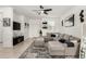 Bright living room with tile flooring, a ceiling fan, and a comfortable sectional sofa at 40467 W Jenna Ln, Maricopa, AZ 85138