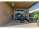 Comfortable covered patio featuring a lounge set with stylish decor, perfect for outdoor relaxation and entertaining at 40467 W Jenna Ln, Maricopa, AZ 85138