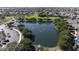 Aerial view showcases a large community lake surrounded by lush landscaping and residential homes at 40866 W Sanders Way, Maricopa, AZ 85138