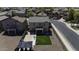 Aerial view of the backyard features a gazebo, artificial turf, a patio, and surrounding neighborhood at 40866 W Sanders Way, Maricopa, AZ 85138