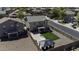 Aerial view of the fenced backyard with artificial turf, patio, gazebo, and neighborhood at 40866 W Sanders Way, Maricopa, AZ 85138