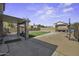 Large backyard with a covered patio, artificial turf, concrete, block wall, and gazebo at 40866 W Sanders Way, Maricopa, AZ 85138