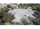 Overhead view of a basketball court with multiple hoops, surrounded by trees and landscaping at 40866 W Sanders Way, Maricopa, AZ 85138