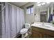 Bathroom featuring a toilet, shower with curtain, vanity, sink, and window at 40866 W Sanders Way, Maricopa, AZ 85138