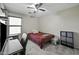 Cozy bedroom with a ceiling fan, window, desk, chair, and storage unit at 40866 W Sanders Way, Maricopa, AZ 85138