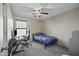 Bedroom with carpeted floors, ceiling fan, and desk at 40866 W Sanders Way, Maricopa, AZ 85138
