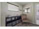 Calm bedroom with a decorative mirror, a chair, and a storage unit at 40866 W Sanders Way, Maricopa, AZ 85138